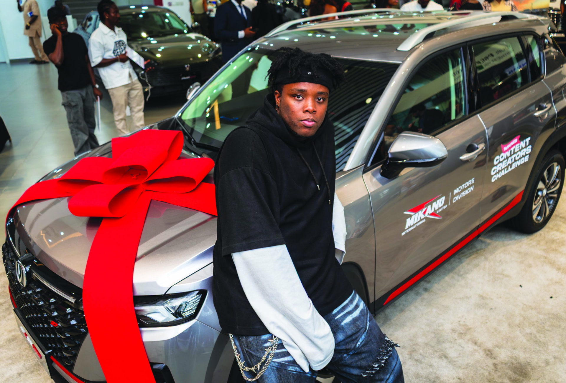 Chibundu Victor Chisom (Vickdance) beside the awarded Changan CS35 at the official presentation.
